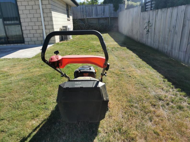 Back lawn freshly mowed in Waihi with the mower still on the grass